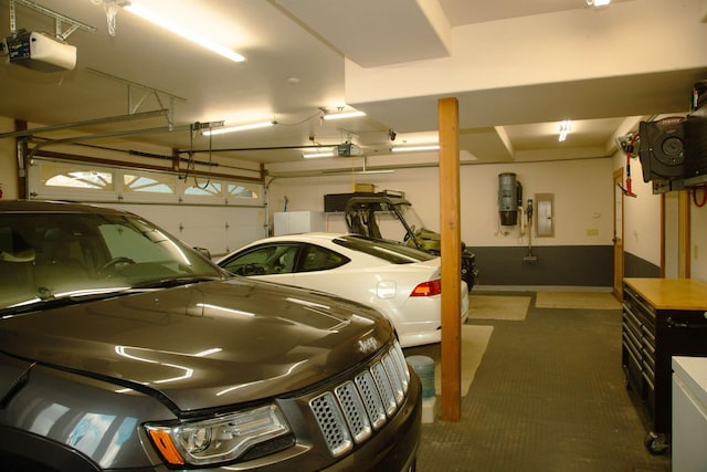 garage with electric panel and a garage door opener