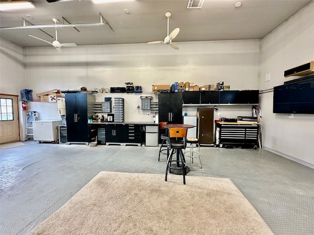 garage with a workshop area and ceiling fan