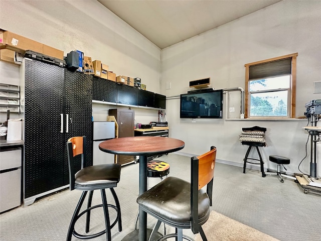 kitchen with a breakfast bar area and light carpet