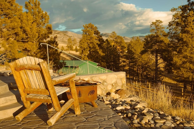 balcony featuring a mountain view and a patio area