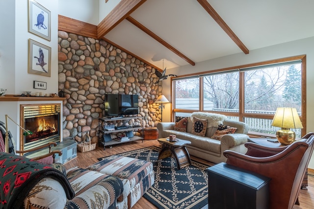 living room with hardwood / wood-style flooring, plenty of natural light, high vaulted ceiling, and beam ceiling