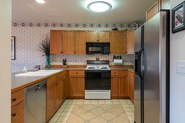 kitchen featuring appliances with stainless steel finishes, light tile patterned floors, and sink