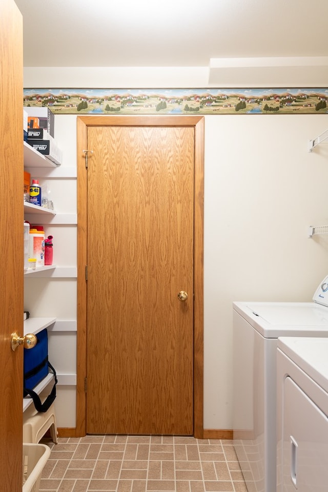 clothes washing area with washing machine and dryer