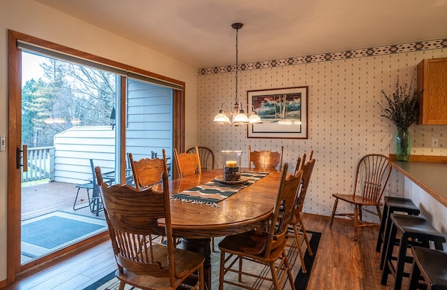 dining room featuring wood-type flooring and a chandelier