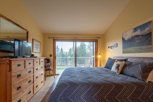 carpeted bedroom featuring access to outside and lofted ceiling