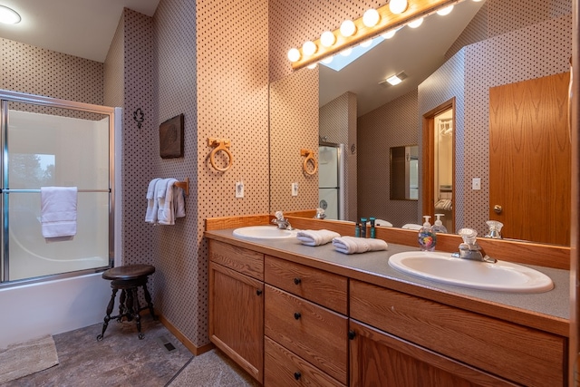 bathroom with bath / shower combo with glass door, vanity, and a skylight