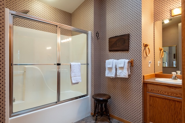 bathroom featuring vanity and combined bath / shower with glass door