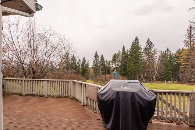 deck with grilling area and a lawn