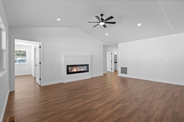 unfurnished living room with dark hardwood / wood-style flooring, ceiling fan, and vaulted ceiling