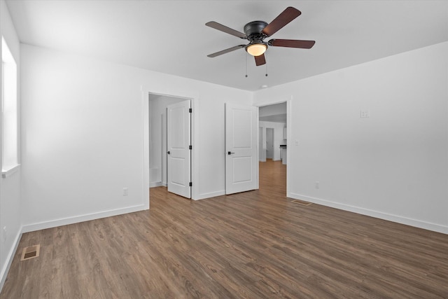 unfurnished bedroom with ceiling fan and dark hardwood / wood-style floors