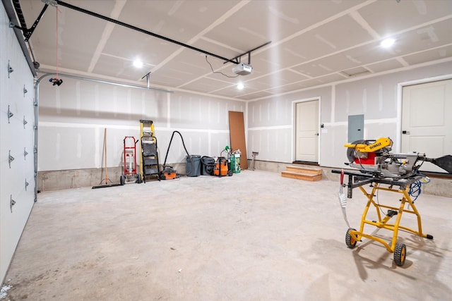 garage with electric panel and a garage door opener