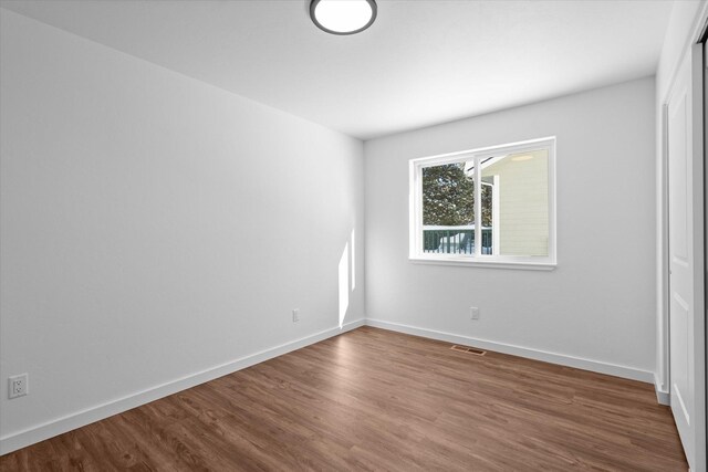 empty room featuring dark wood-type flooring