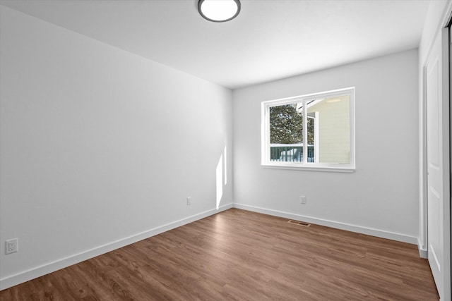 unfurnished room featuring wood-type flooring