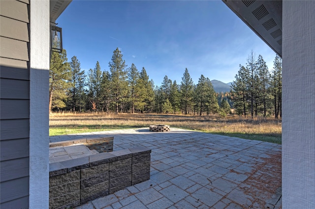 view of patio with a fire pit