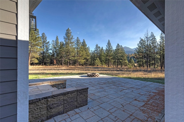5975 Candlewick Ln, Missoula, MT 59808 - view of patio with an outdoor fire pit and a mountain view
