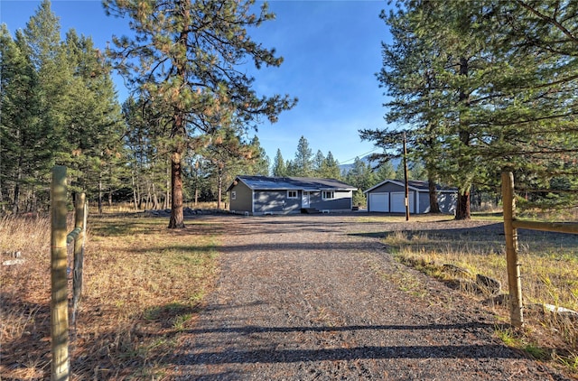 ranch-style home featuring an outbuilding and a garage