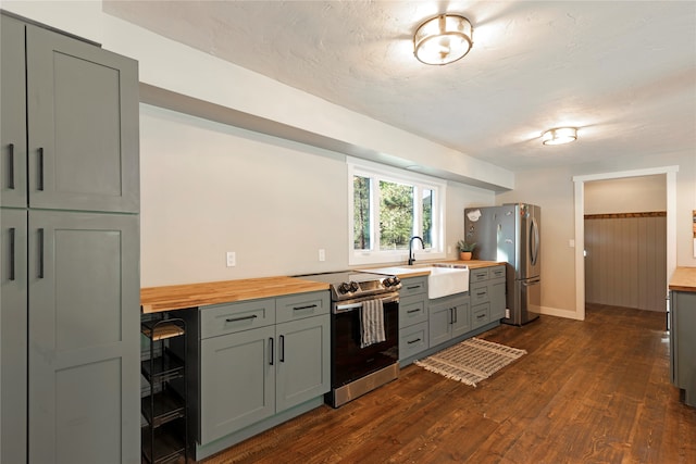 kitchen featuring wine cooler, wood counters, dark wood-type flooring, sink, and stainless steel appliances