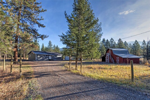 ranch-style home with a garage and an outbuilding