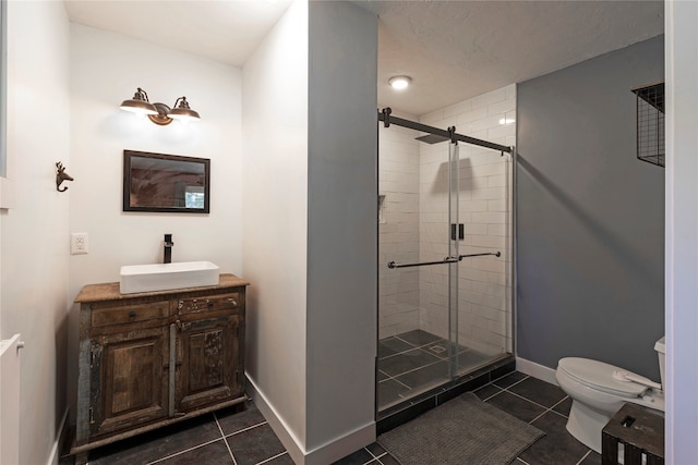 bathroom featuring walk in shower, tile patterned floors, toilet, and vanity