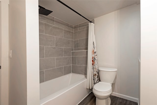 bathroom with hardwood / wood-style floors, shower / tub combo, and toilet