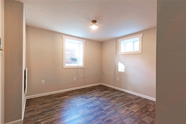 spare room with dark hardwood / wood-style floors