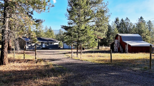 exterior space featuring a garage and an outdoor structure