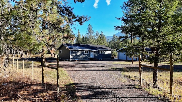 view of front facade with a garage and an outbuilding