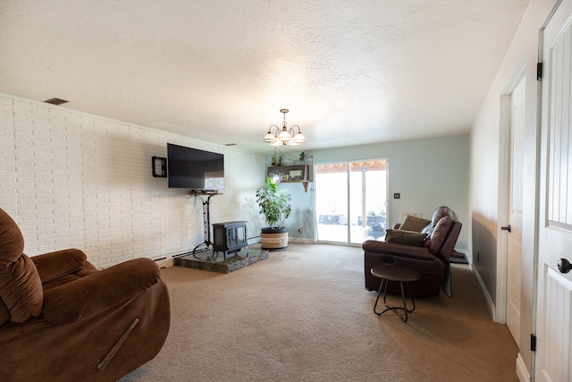 living room featuring carpet flooring, a wood stove, brick wall, and an inviting chandelier