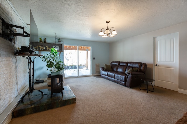 living room with carpet floors, a textured ceiling, and an inviting chandelier