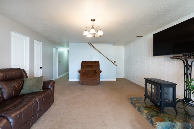 living room with a wood stove, carpet floors, a textured ceiling, and a chandelier