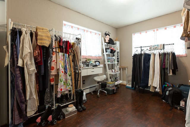 walk in closet with dark hardwood / wood-style floors