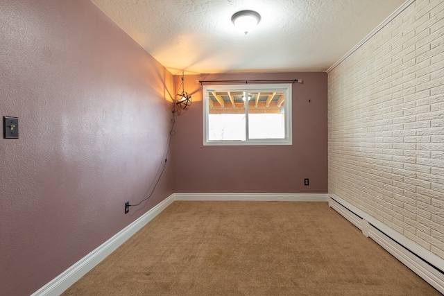 unfurnished room with baseboard heating, carpet floors, brick wall, and a textured ceiling