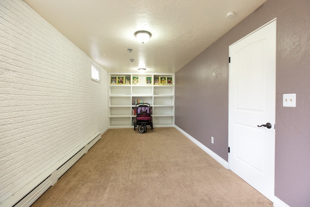 interior space with light carpet, a textured ceiling, and a baseboard radiator