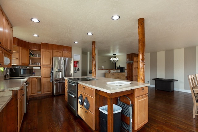 kitchen featuring a textured ceiling, a kitchen island, dark hardwood / wood-style flooring, and sink