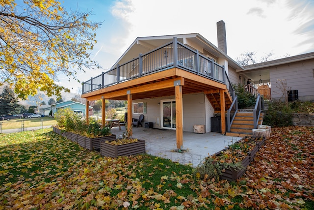 rear view of house with a patio area and a deck