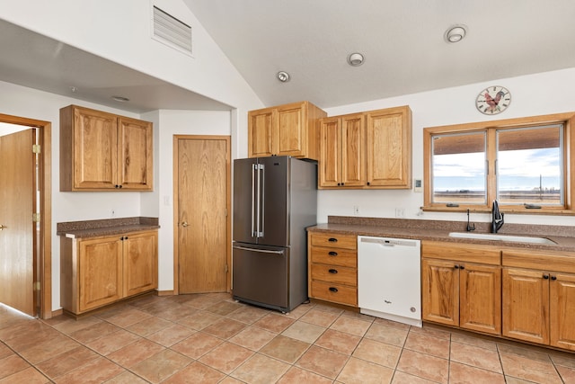 451 1st Rd NE, Fairfield, MT 59436 - kitchen with white dishwasher, high end fridge, lofted ceiling, dark countertops, and light tile patterned floors