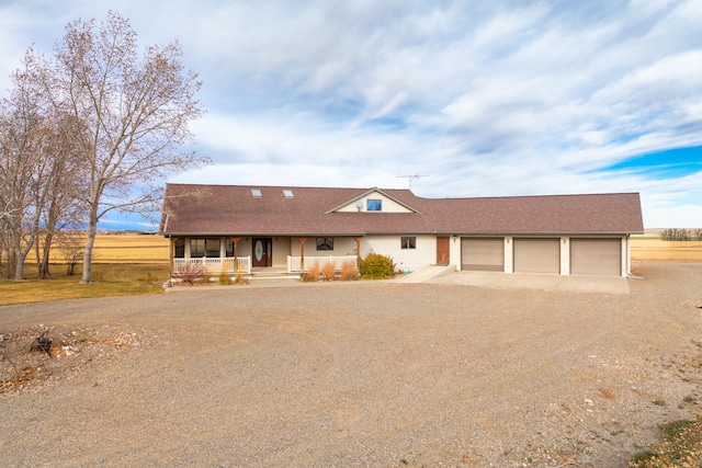 451 1st Rd NE, Fairfield, MT 59436 - view of front of property with covered porch, dirt driveway, an attached garage, and a shingled roof