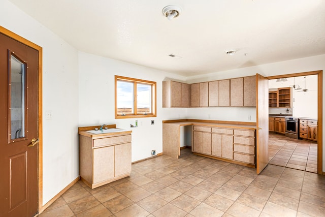 451 1st Rd NE, Fairfield, MT 59436 - kitchen featuring light brown cabinetry, stainless steel stove, and light countertops
