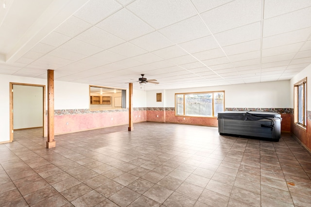 451 1st Rd NE, Fairfield, MT 59436 - unfurnished living room featuring wainscoting, a paneled ceiling, and a ceiling fan