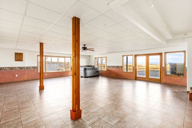 451 1st Rd NE, Fairfield, MT 59436 - unfurnished living room with a wainscoted wall, a drop ceiling, and a ceiling fan