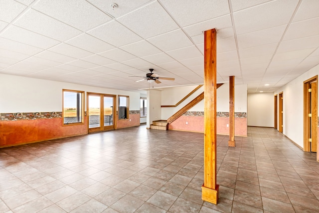 451 1st Rd NE, Fairfield, MT 59436 - unfurnished living room featuring a paneled ceiling, a wainscoted wall, and a ceiling fan