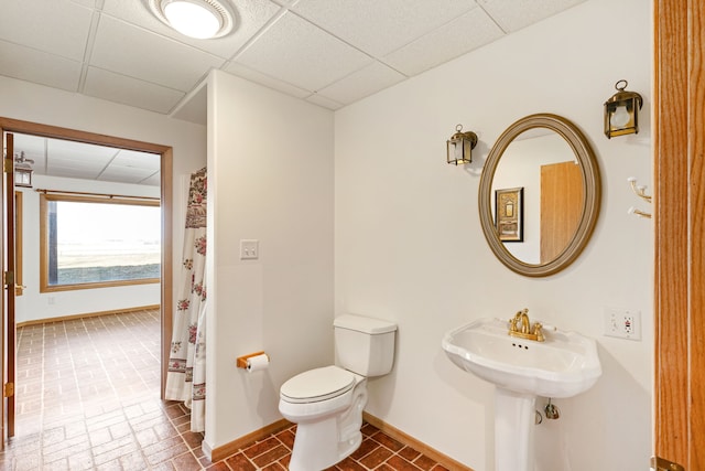451 1st Rd NE, Fairfield, MT 59436 - bathroom with a drop ceiling, a shower with curtain, and brick patterned flooring