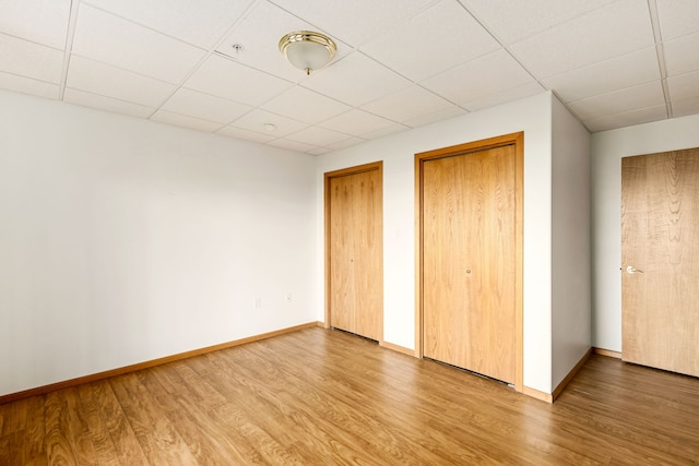 451 1st Rd NE, Fairfield, MT 59436 - unfurnished bedroom with wood finished floors, multiple closets, and a paneled ceiling