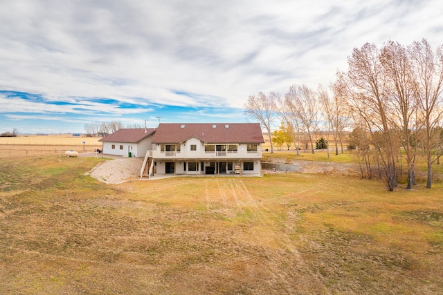 451 1st Rd NE, Fairfield, MT 59436 - back of property featuring stairway, a yard, and a wooden deck