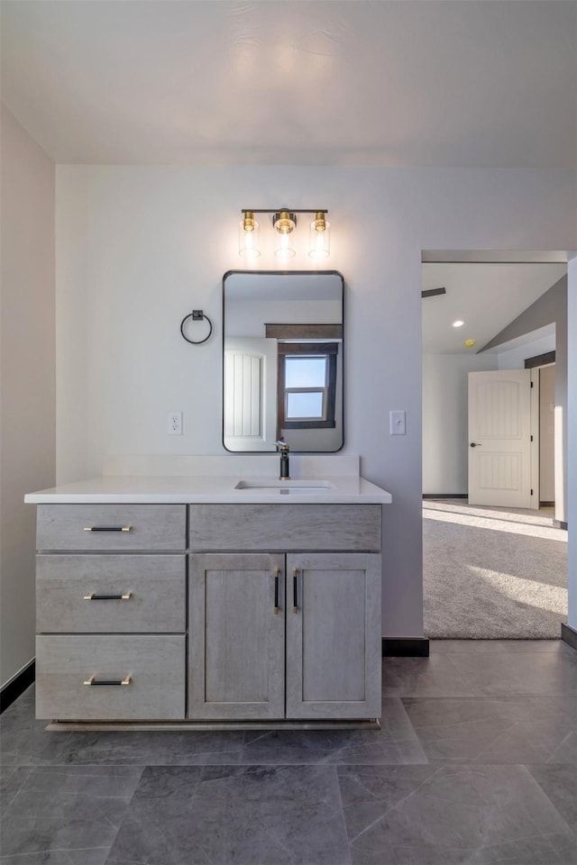 bathroom with vanity and vaulted ceiling