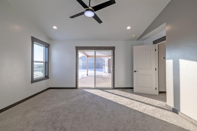 unfurnished room featuring ceiling fan, lofted ceiling, and light colored carpet