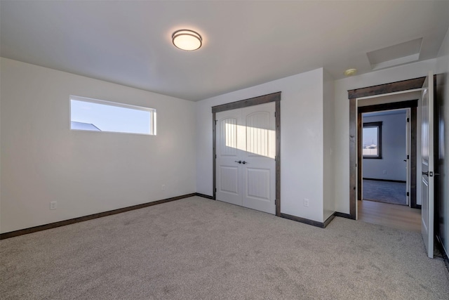 unfurnished bedroom with light carpet and a closet