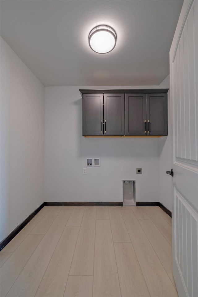 laundry room with light hardwood / wood-style floors, hookup for an electric dryer, hookup for a washing machine, and cabinets