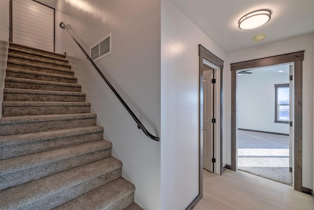 staircase featuring wood-type flooring