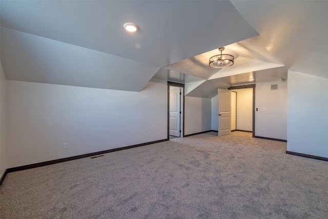 additional living space featuring light carpet and lofted ceiling